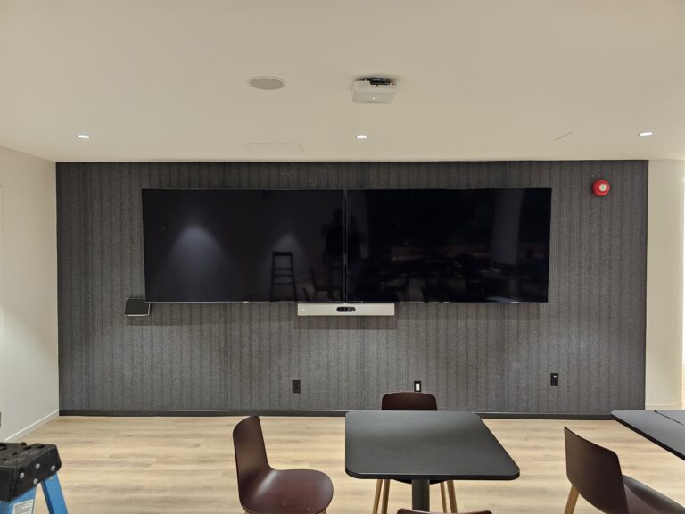 Dual 86-inch commercial display installation in corporate setting by Alanson Media